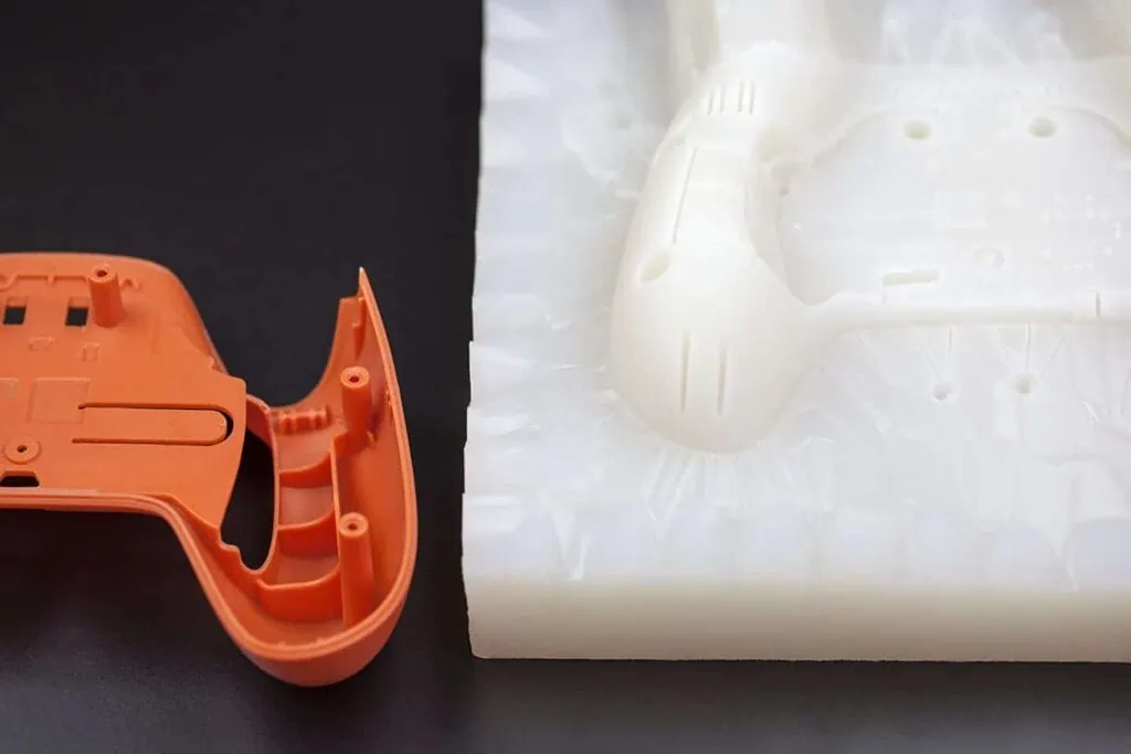 DEBAOLONG SEIKO vacuum cast plastic part next to silicone mold for prototype manufacturing